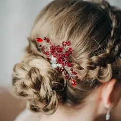 Eleganckie fryzury komunijne z warkoczem i ozdobą z czerwonych koralików. Delikatny warkocz oplata głowę, tworząc romantyczną całość.