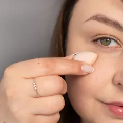 Delikatne muśnięcie gąbeczką to klucz do tego, jak nakładać korektor pod oczy, by uzyskać naturalny efekt.