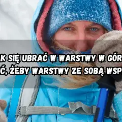 Kobieta w zimowej kurtce i czapce, z niebieskimi oczami, przygotowuje się do wędrówki. Dowiedz się, jak ubrać się w góry warstwowo.