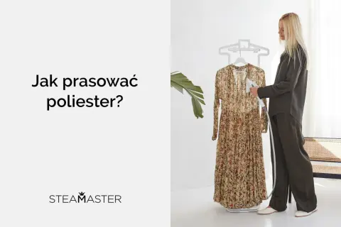 Kobieta pokazuje, jak prasować poliester za pomocą parownicy. Długa, kwiecista sukienka wisi na wieszaku.