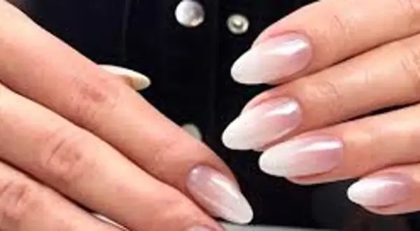 Eleganckie paznokcie ombre french w odcieniach bieli i różu, subtelnie przechodzące w perłowy blask.