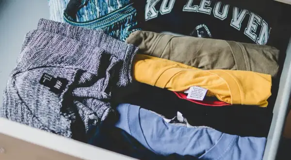 Ubrania w szufladzie, od swetra po t-shirty. Dowiedz się, jak pozbyć się zapachu stęchlizny z ubrań, by cieszyć się świeżością.